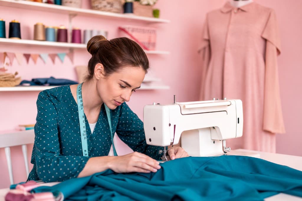 Woman tailor at sewing machine
